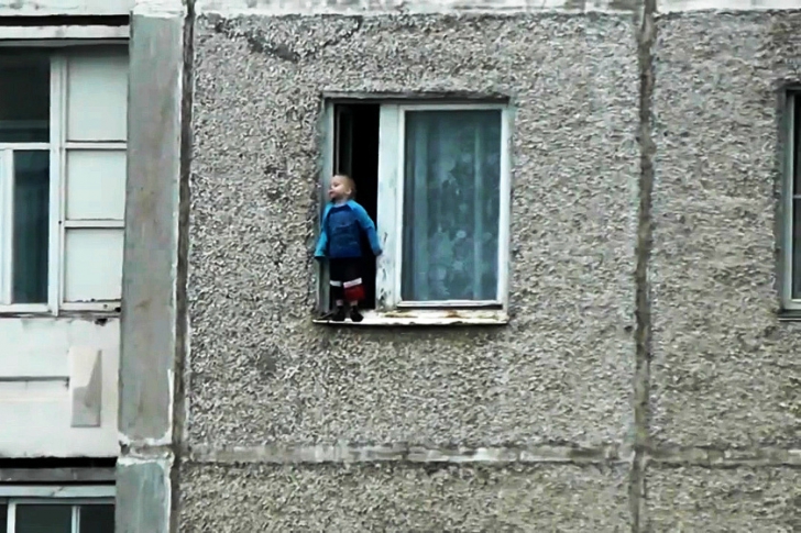 VIDEO ŞOCANT. La un pas de moarte. Un copil se joacă pe pervazul geamului, în picioare, la etajul 8