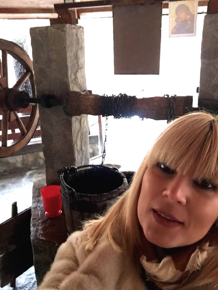 Elena Udrea, în vizită la mănăstire. Haină de blană, selfie la fântână şi poze cu iepuri