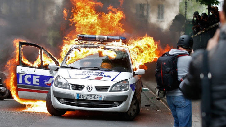 Proteste violente în Paris. O maşină a poliţiei a fost incendiată