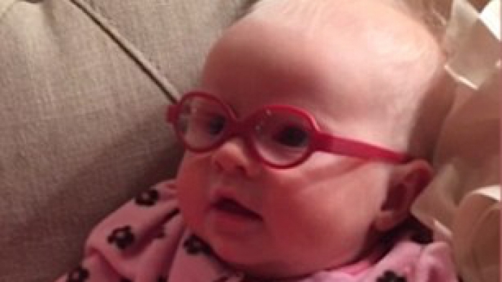 Reacţia care a topit internetul: o fetiţă de 3 luni îşi vede prima dată mama cu ochelarii primiţi