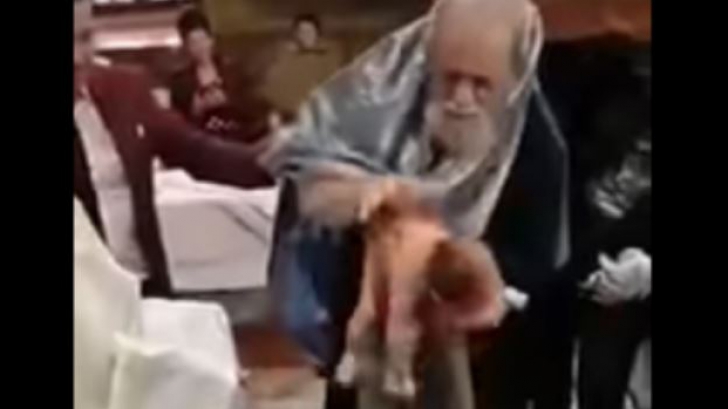Preotul care a bruscat un bebeluș la botez, suspendat timp de 30 de zile