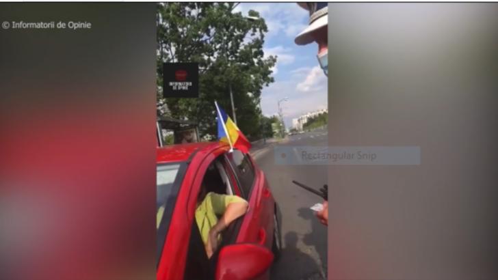femeie oprita in trafic din cauza steagului de la geam